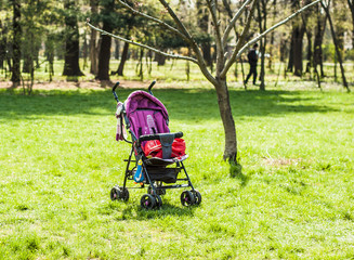 Colorful pram on the grass in a park