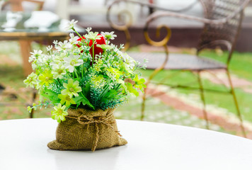 Decorative flower in sack on white table
