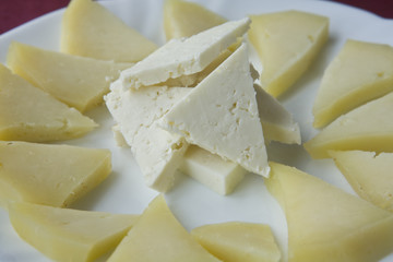 Slices of cottage and aged cheese