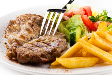 Grilled steak, French fries and vegetables