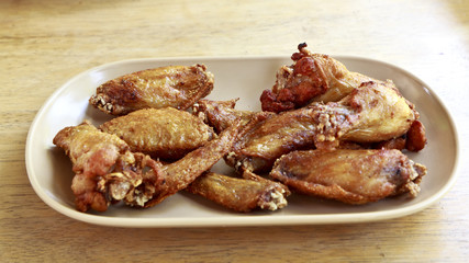 chicken wings in white dish on wooden background