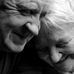 happy older pair on a black background
