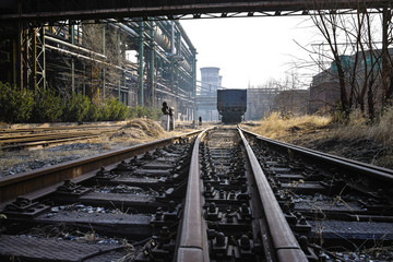 Fototapeta na wymiar Rusted railway and abandoned steelmaking equipments