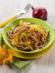 spaghetti with pumpkin flowers and onions, selective focus