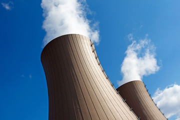 Cooling towers of a  nuclear power plant against sky and clouds