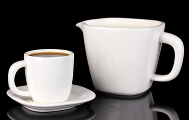 A cup of strong coffee and sweet cream isolated on black