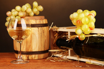 Wooden case with wine bottle, barrel, wineglass and grape