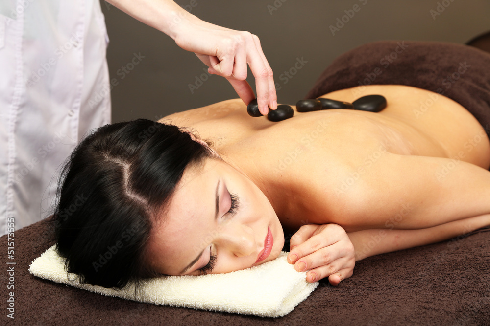 Canvas Prints Beautiful young woman in spa salon with spa stones,