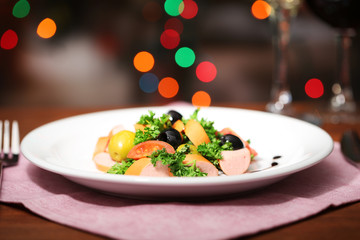 Tasty salad on dark background with bokeh  defocused lights