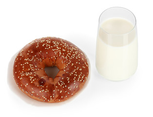 Bread roll and glass of milk isolated on white