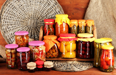 Different conservations on shelves on wooden background