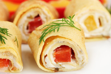 Egg rolls with cheese cream and paprika,on plate, close up