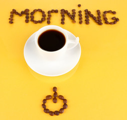 Cup of strong coffee on yellow background