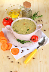 Nourishing soup in pink pan with ingredients