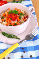 Delicious rice with vegetables and herbs in pot