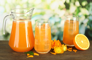 Fototapeta na wymiar Glasses and pitcher of orange juice
