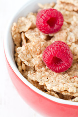 flakes with raspberries in red bowl