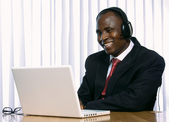 african amercian businees man working on his laptop