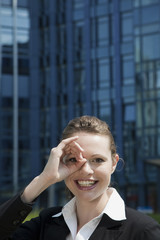 Young woman looking through hand