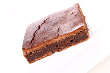 Slice of a brownie on white background