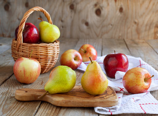 Fresh ripe pears and apples on wooden table
