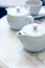 Closeup image of teapots on a table in cafe