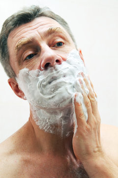 Image of mature man shaving