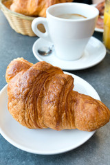 Breakfast with coffee and croissants