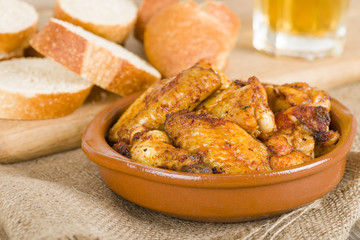 Pollo al Ajillo (Garlic Chicken Wings) with crusty bread & beer.