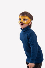 boy wearing a carnival mask, pretending to be a superhero