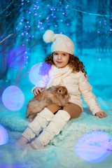 Little winter girl with rabbit