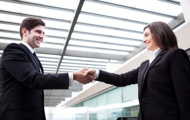 Handshake between business people at modern office