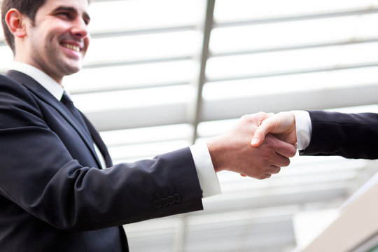 Business People Handshaking Closing A Deal