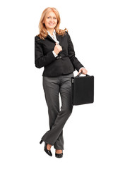 Full length portrait of a mature businesswoman leaning against a