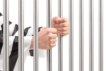 Obraz premium Male holding prison bars