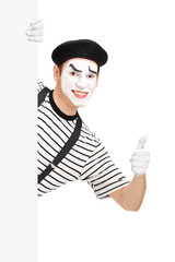 Mime dancer giving a thumb up behind a white panel