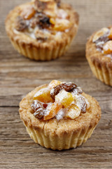 Homemade tart with dried fruits on wooden table