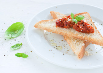 Toast with red tomato italian pesto and fresh basil