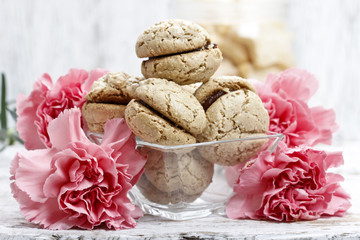 Parisian macarons among pink carnation flowers