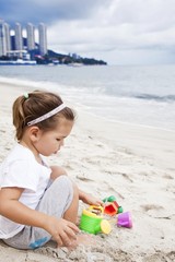 Asian toddler girl playing with beach toys