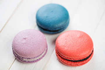 Three brightly coloured french macaroons, horizontal shot