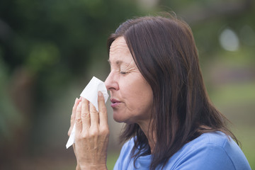 Woman suffering flu or hayfever outdoor