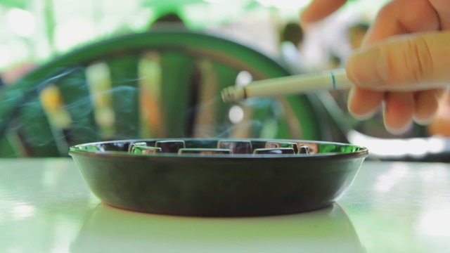 Cigarette and ashtray.