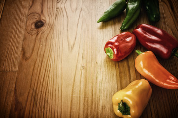 Peppers on wooden background