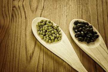 Soybeans and black beans in wooden spoons