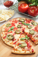 Pizza with cheese, ham and jalapeno pepper