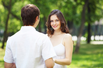 Obraz premium Young love Couple smiling under blue sky