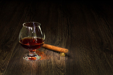 Cognac, cigar and an old book nearby