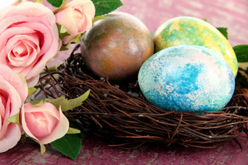 Obraz na płótnie Canvas Easter eggs in nest on pink background