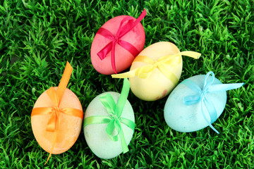 Colorful eastern eggs on  grass background